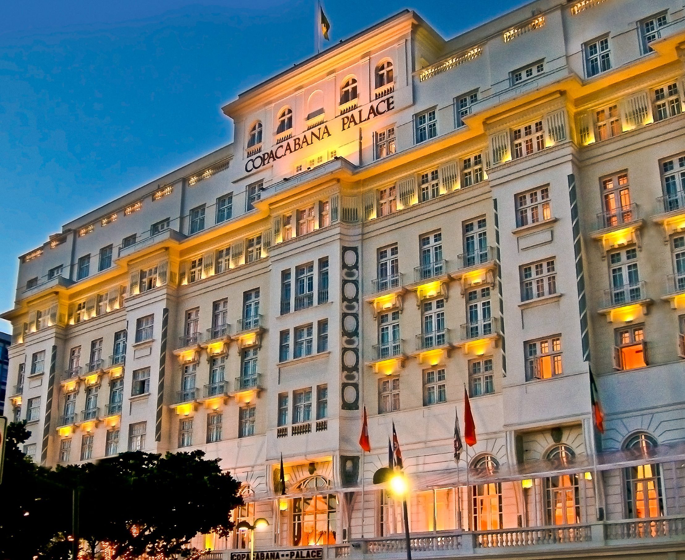 The Copacabana Palace at dusk — the address that taught Rio what a grand hotel is.